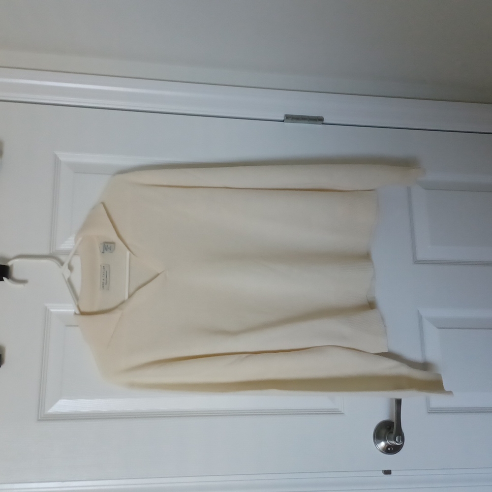 Beautiful cream colored collared v-neck sweater.